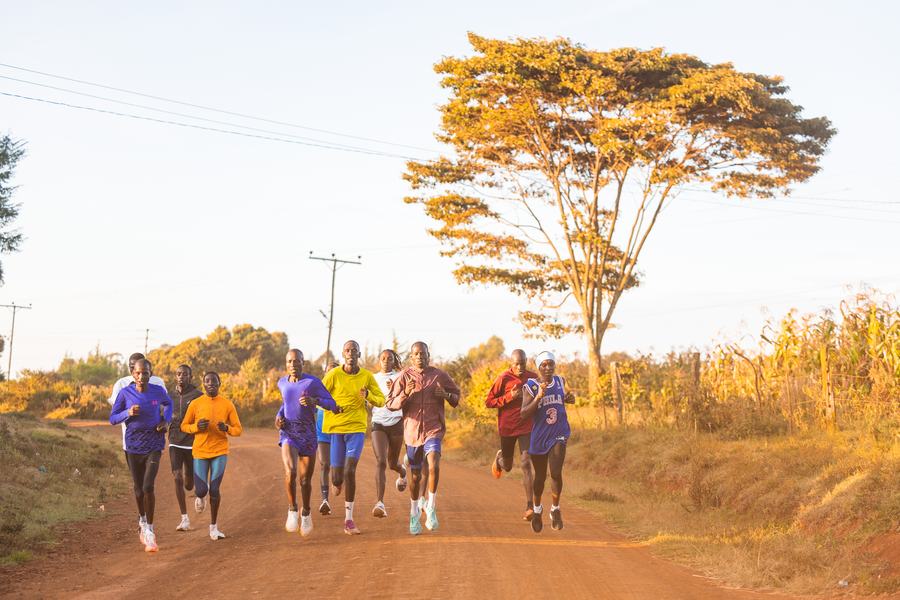Training group on a red dirt road in Kenya at sunrise