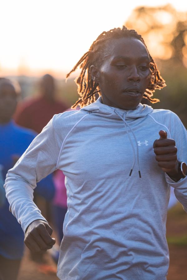 Runner in a white hoodie at sunrise