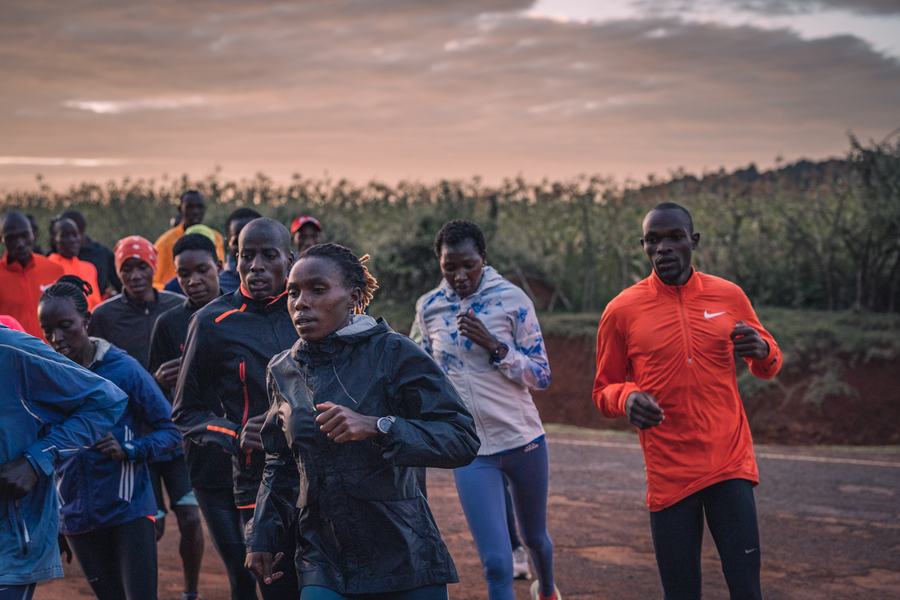 Runners gathered beside the maize field