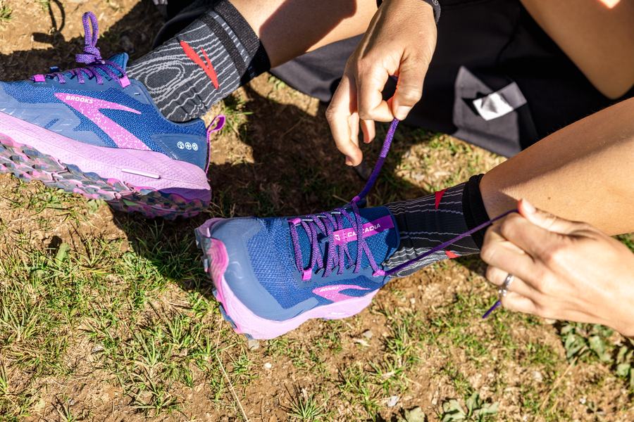 Lacing a trail shoe in the grass