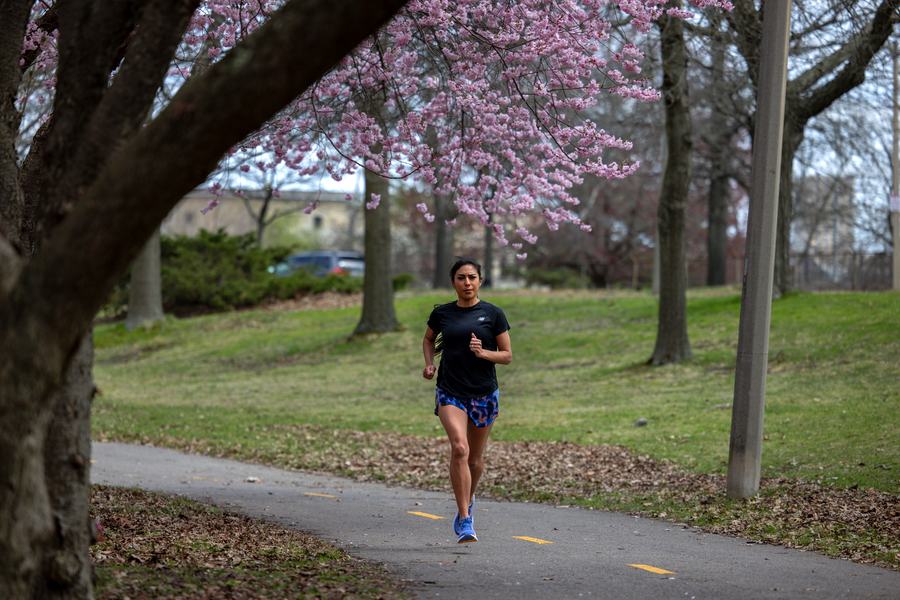 Running toward camera under blossoms