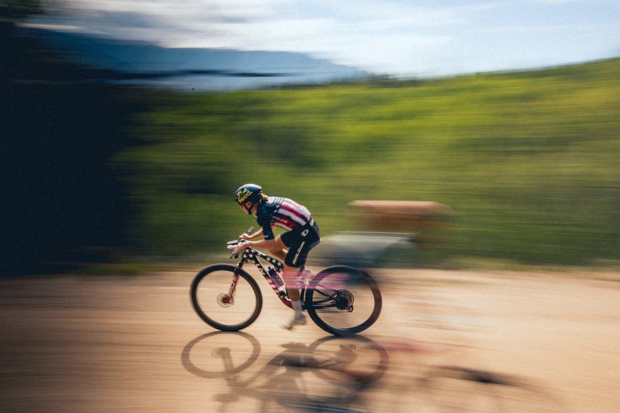 A rider panned against the mountain road