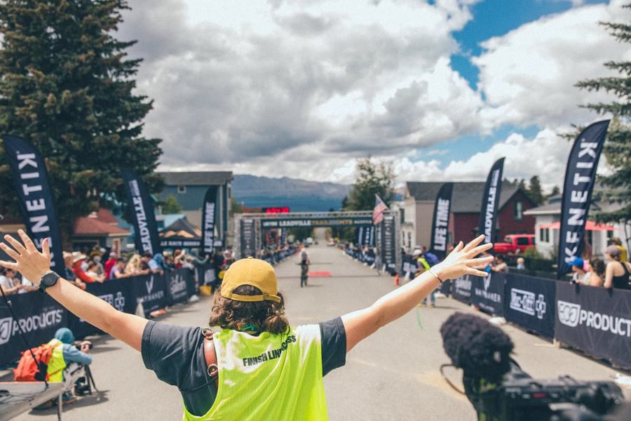 Arms wide across the finish