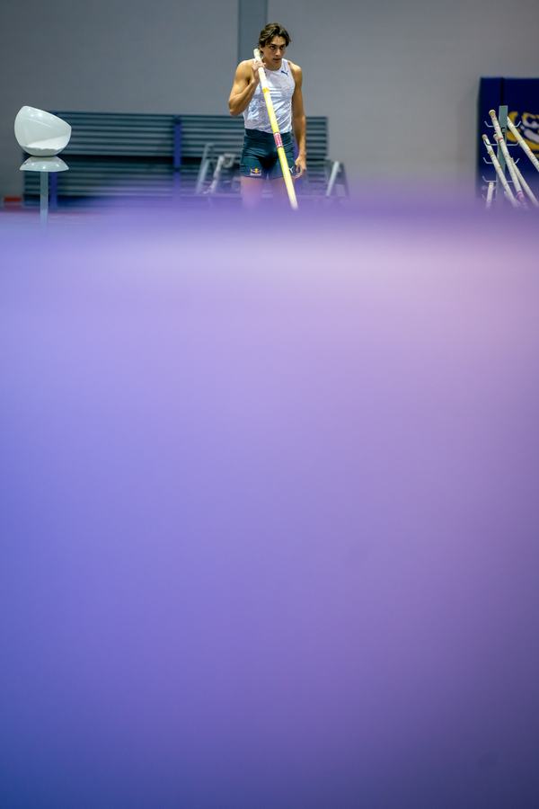 Small figure above an empty purple wall
