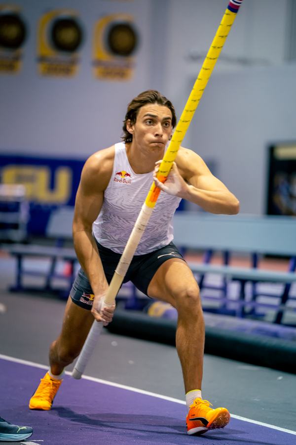 Carrying the pole toward the runway