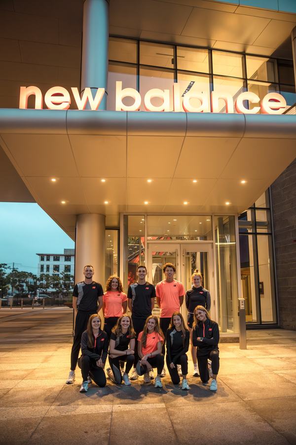 The team under the New Balance sign at dusk