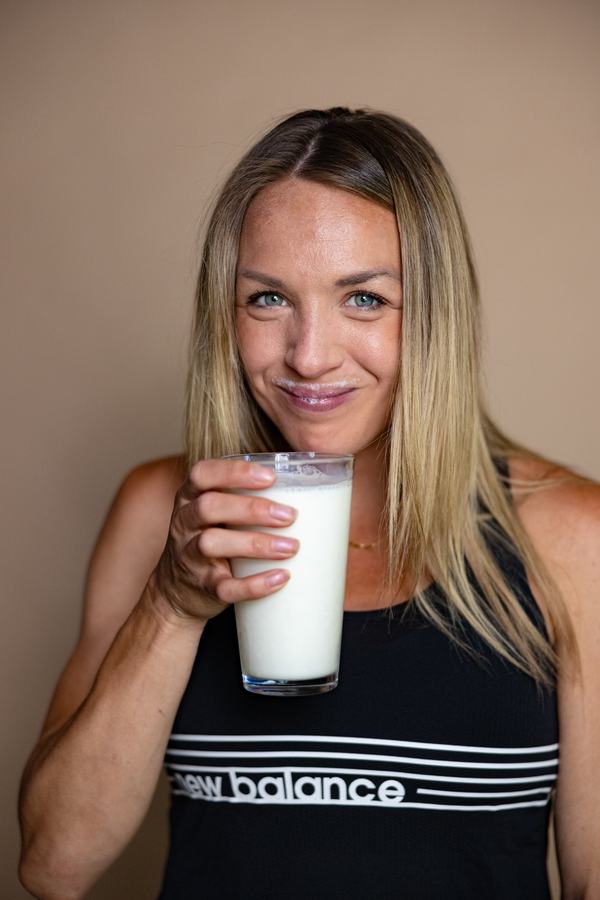 A glass of milk, smiling