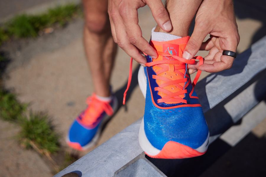 Runner lacing a New Balance shoe