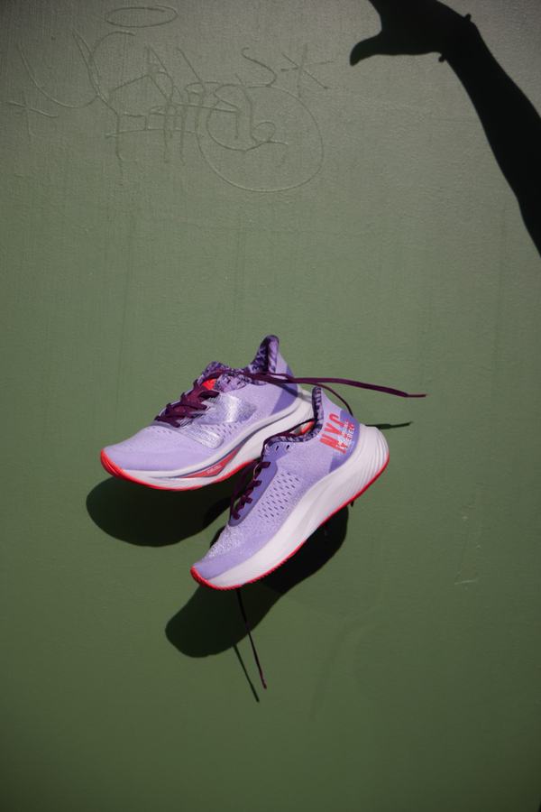 Lavender colorway pair against a green wall