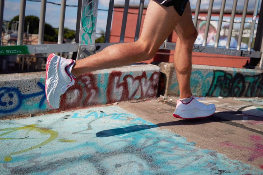 Runner passing a graffiti wall