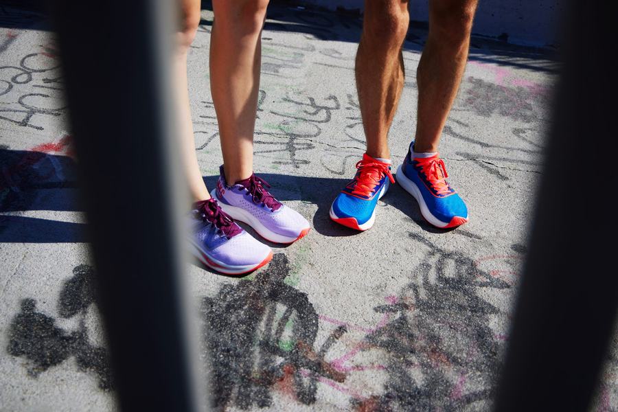 Two runners framed through railings