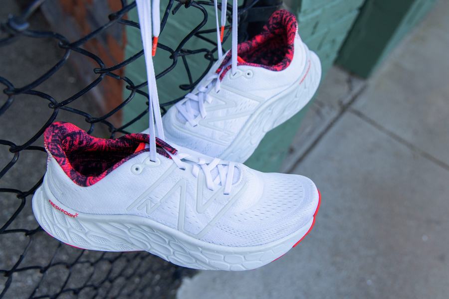 White race shoe at a chain-link fence