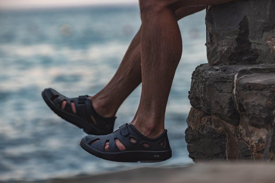 Feet on the rocks, sea behind