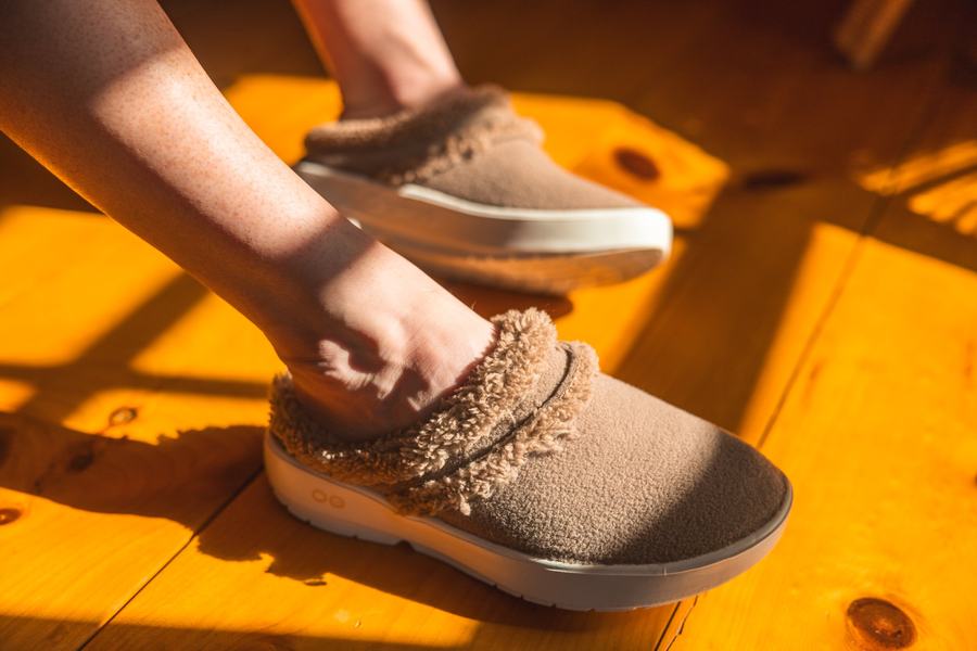 Pulling on a slipper, warm light