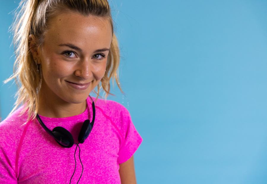 Pink top on blue, headphones