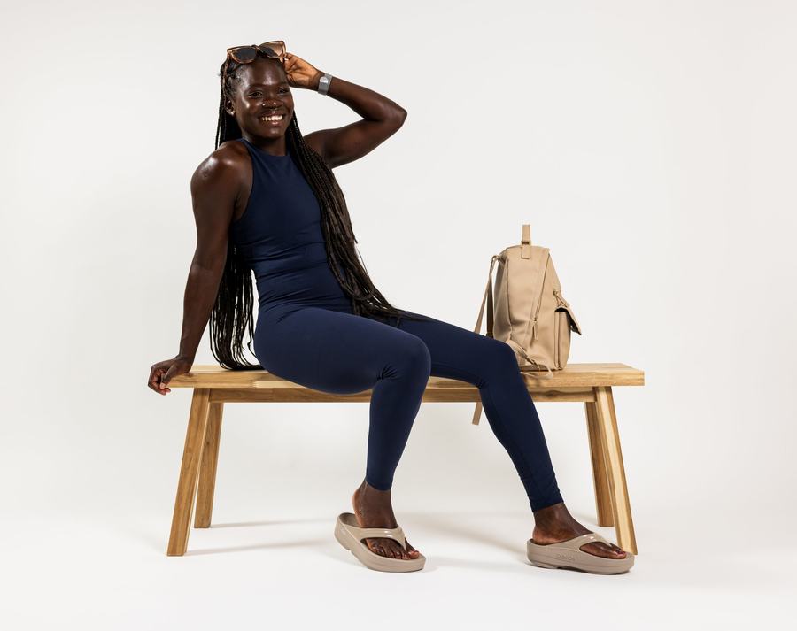On the bench, bag beside
