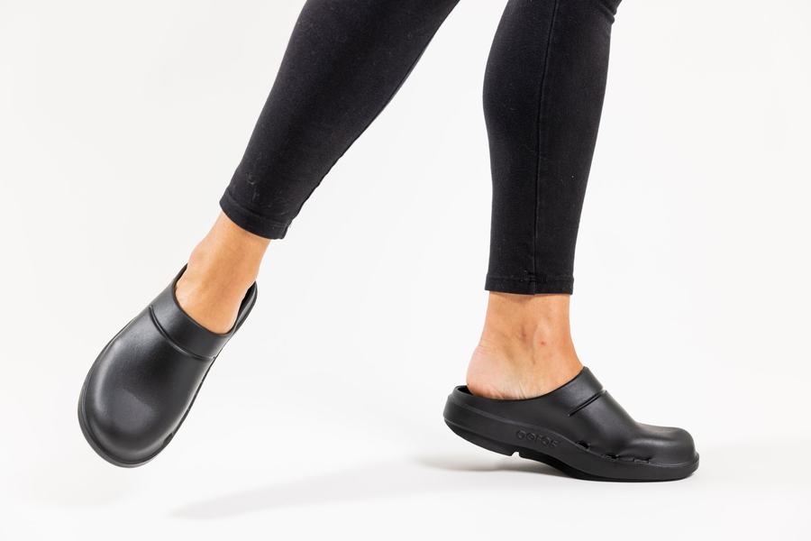 Black clog, mid-step