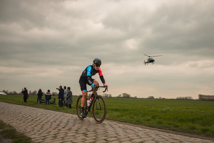 A rider alone, helicopter above