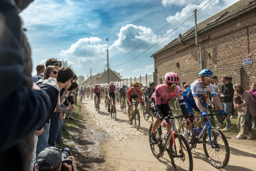 The peloton through a cobbled village