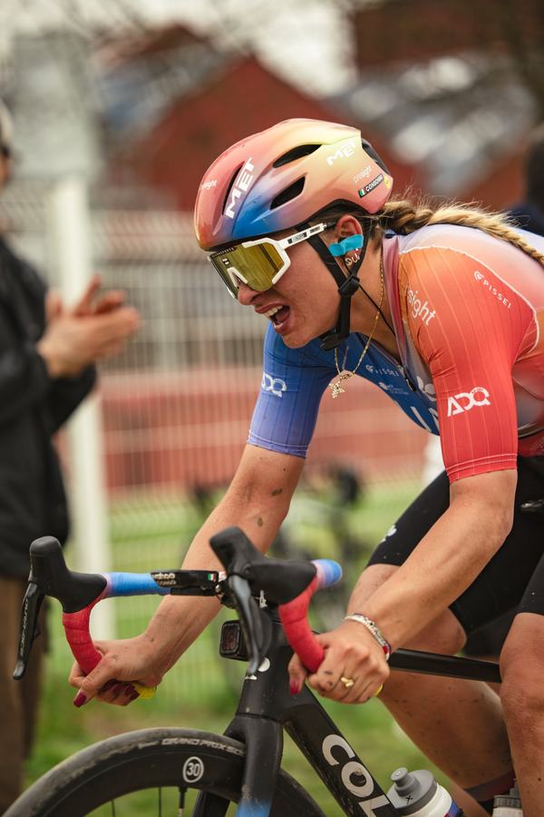 A rider on the cobbles, head down