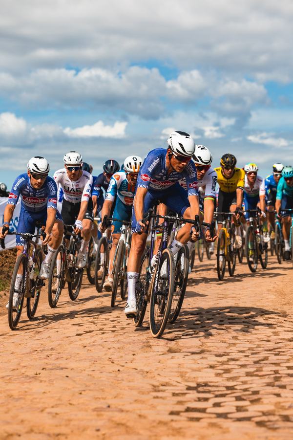 The peloton across the cobbles