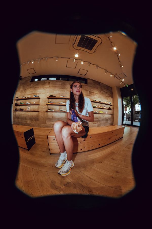 Julia in the Saucony store, through a fisheye