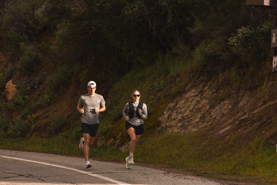 Two runners on a canyon road