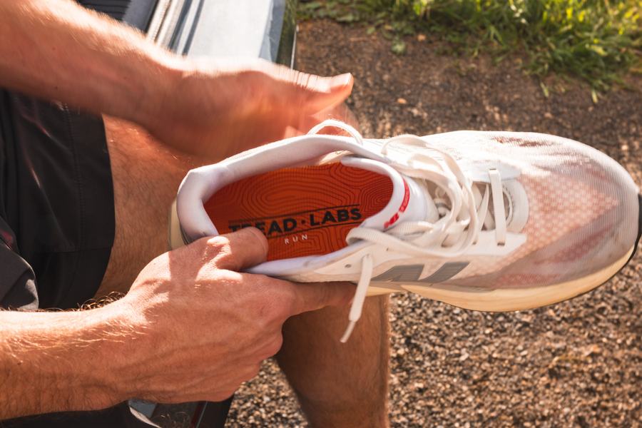 Sliding the insole into a running shoe