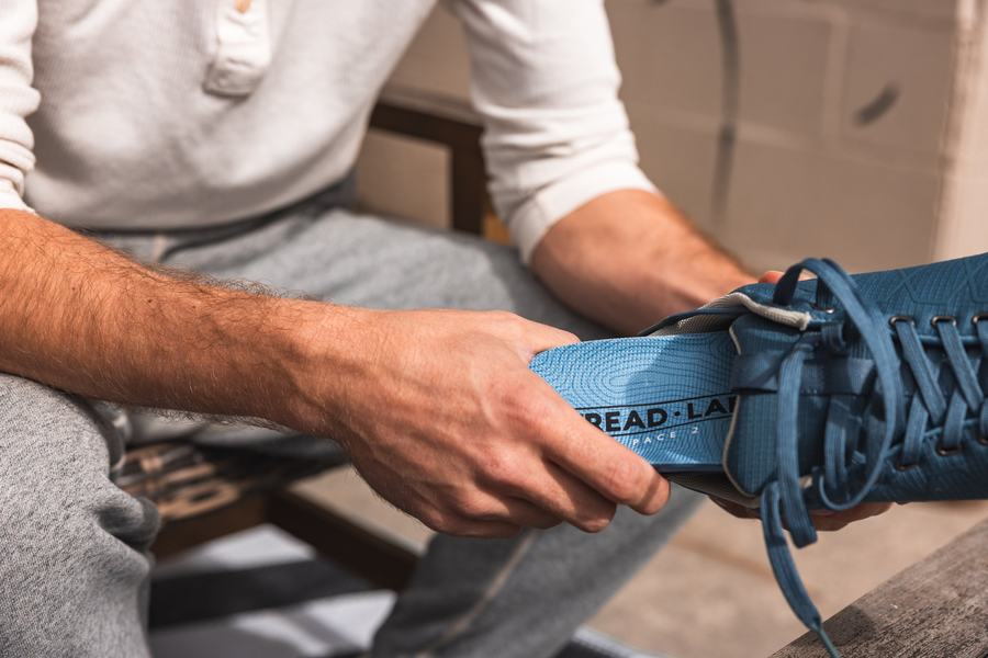 Blue insole going into a shoe at home