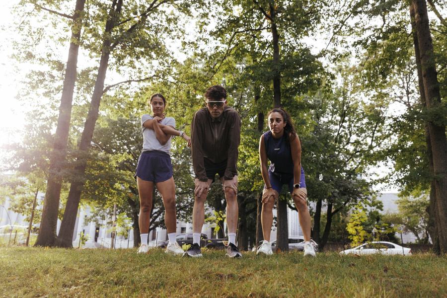 Three runners on a wooded trail
