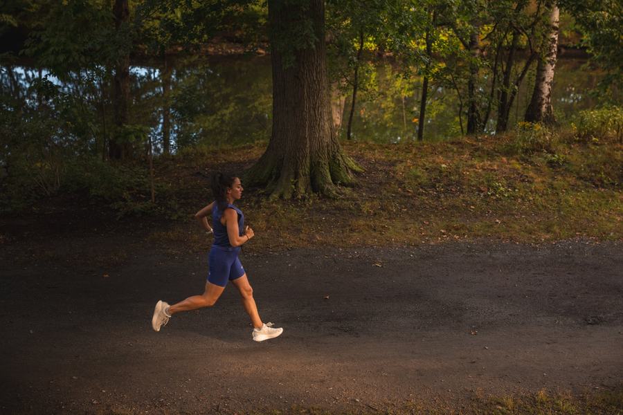 A runner alone under the trees