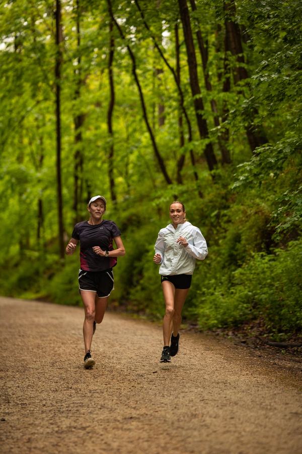Two runners on a forest trail