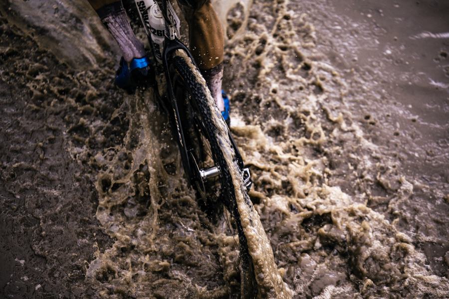 A bike pushed through deep mud